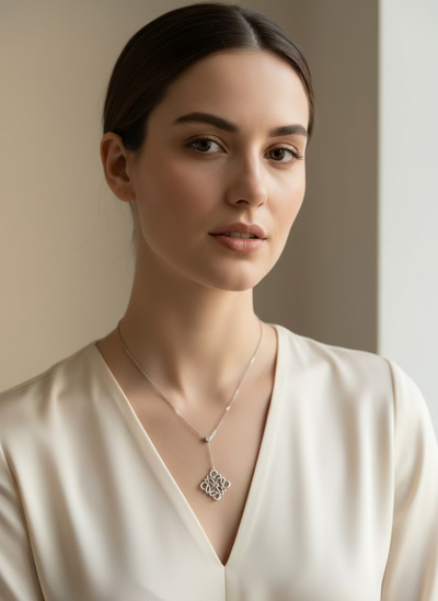 Woman wearing a delicate necklace with a subtle background